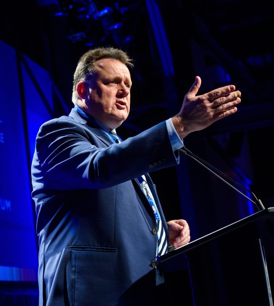Mayor Mike Savage stands at podium for an event in Halifax